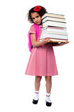 Little girl with backpack and books