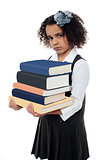 Unhappy school girl with pile of books