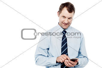 Smiling executive using mobile phone