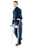 Man walking with crutches isolated on white