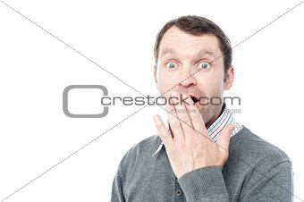 Shocked man covering his mouth with hand