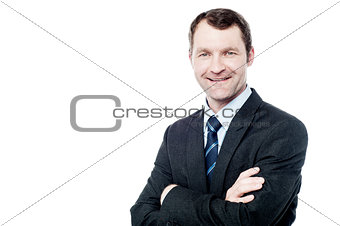 Cheerful businessman with arms folded