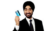 Happy male executive holding credit card