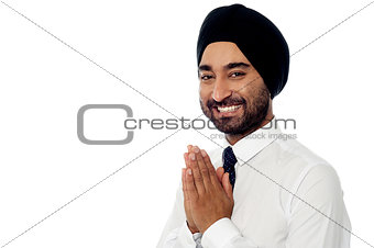 Smiling young businessman greeting