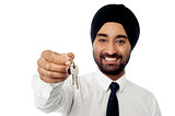 Smiling corporate guy holding a house key