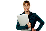 Smiling secretary holding laptop