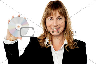 Smiling female manager showing compact disc