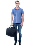 Smiling casual man standing with bag