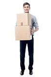 Young man holding cardboard boxes