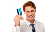 Smiling corporate guy holding credit card