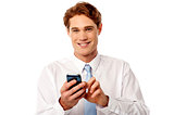 Smiling business executive using mobile phone