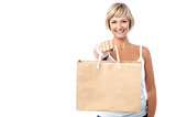 Woman holding paper shopping bag