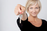 Happy smiling woman showing a key
