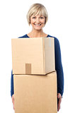 Beautiful woman carrying cardboard boxes