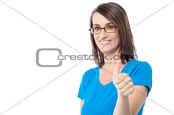 Smiling woman showing thumbs up gesture