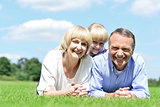 Lovable family of three lying in the park
