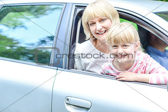 Happy mother and daughter in car