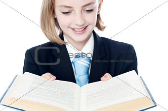 Smiling teen girl looking at a book