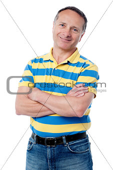 Senior man posing with arms folded