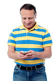 Casual aged man using mobile phone