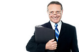 Smiling businessman holding file folders