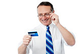 Smiling executive holding credit card