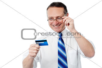 Smiling executive holding credit card