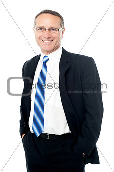 Businessman posing with hands in pockets