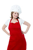Smiling senior woman chef, isolated over white