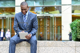 Relaxed businessman using his tablet pc