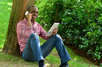 African man with smart phone and tablet