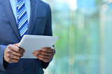 Cropped image of businesman with digital tablet