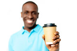 Smiling man holding beverage cup