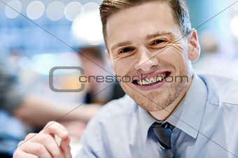 Smiling relaxed young man in restaurant