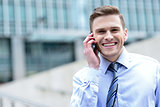 Smiling businessman talking on the phone