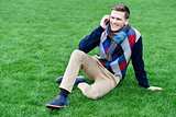 Relaxed young fashion guy on call
