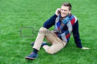 Relaxed young fashion guy on call