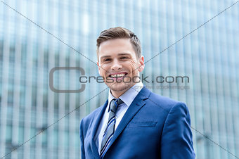 Businessman standing outside modern building