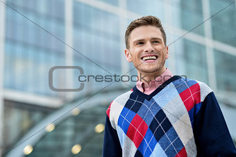 Handsome smiling man posing outdoor