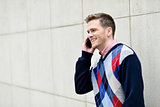 Young man busy in a phone conversation