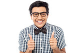 Young man showing double thumbs up