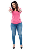 Young woman showing double thumbs up