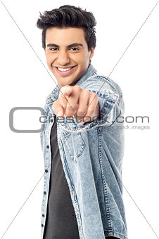 Happy young man pointing at you