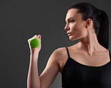 Fitness woman working out with green dumbbell
