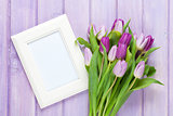 Purple tulip bouquet and blank photo frame