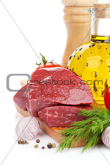 Raw fillet beef steak and spices on cutting board