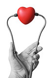Hand with stethoscope and heart