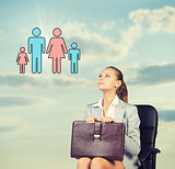 Business woman in skirt, blouse and jacket, sitting on chair imagines family. Against background of sky, clouds