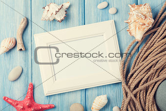 Sea vacation with blank photo frame, star fish and marine rope