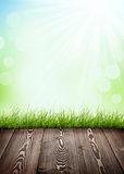Summer background with wooden floor, green grass and bokeh